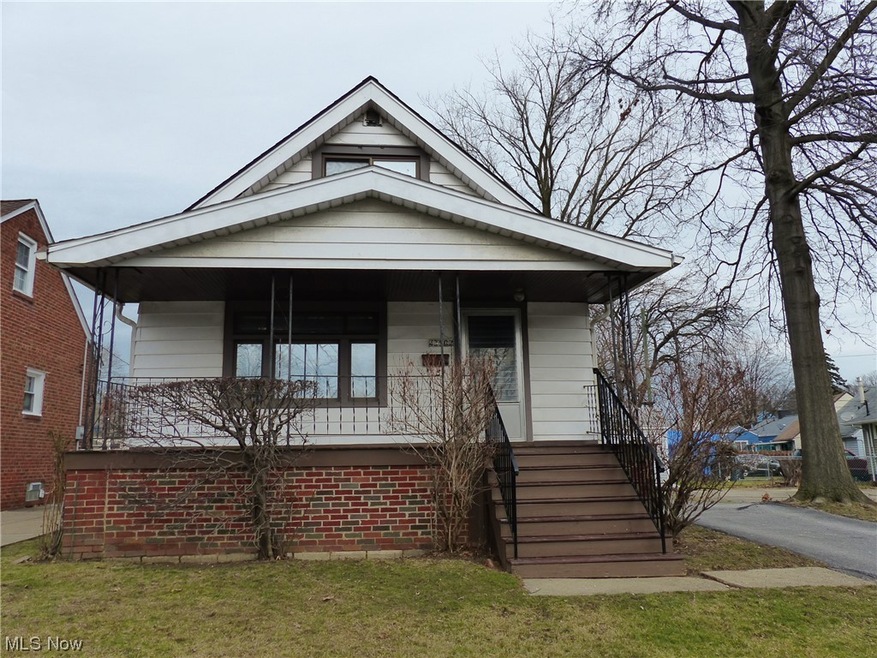 Bungalow-style house with a front lawn and a porch