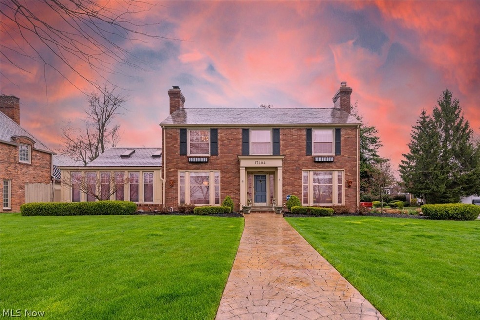 Colonial inspired home featuring a lawn