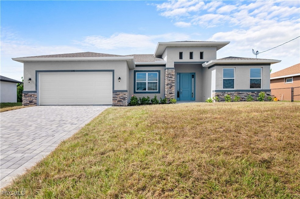 Prairie-style home with stone siding, stucco siding, a front lawn, and decorative driveway