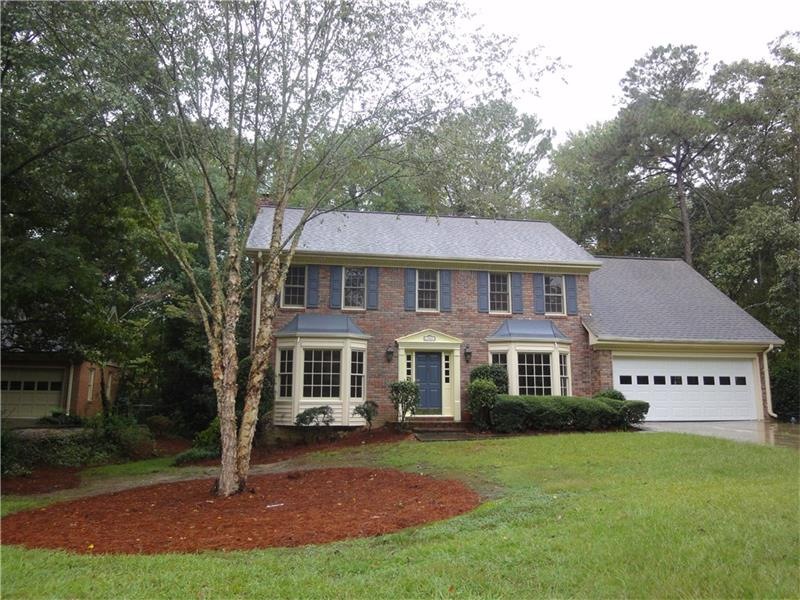 Traditional colonial brick front home located on a