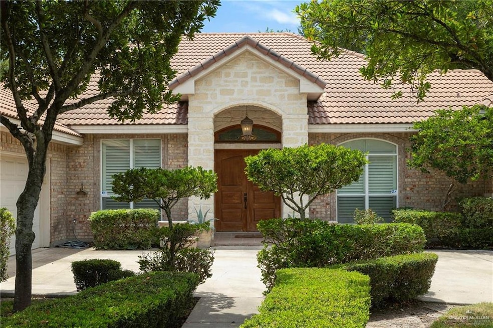 View of front facade with a tiled roof and stone siding
