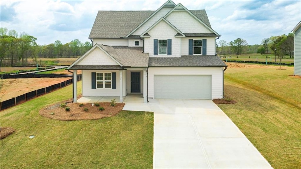 View of front of home with a front yard, a shingle