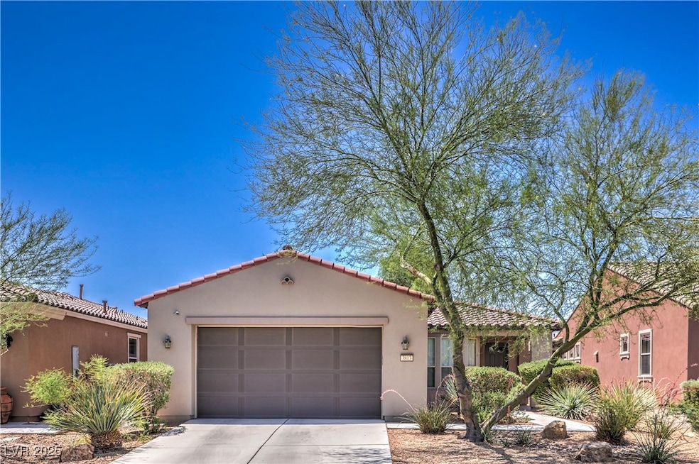 Mediterranean / spanish-style home with an attache