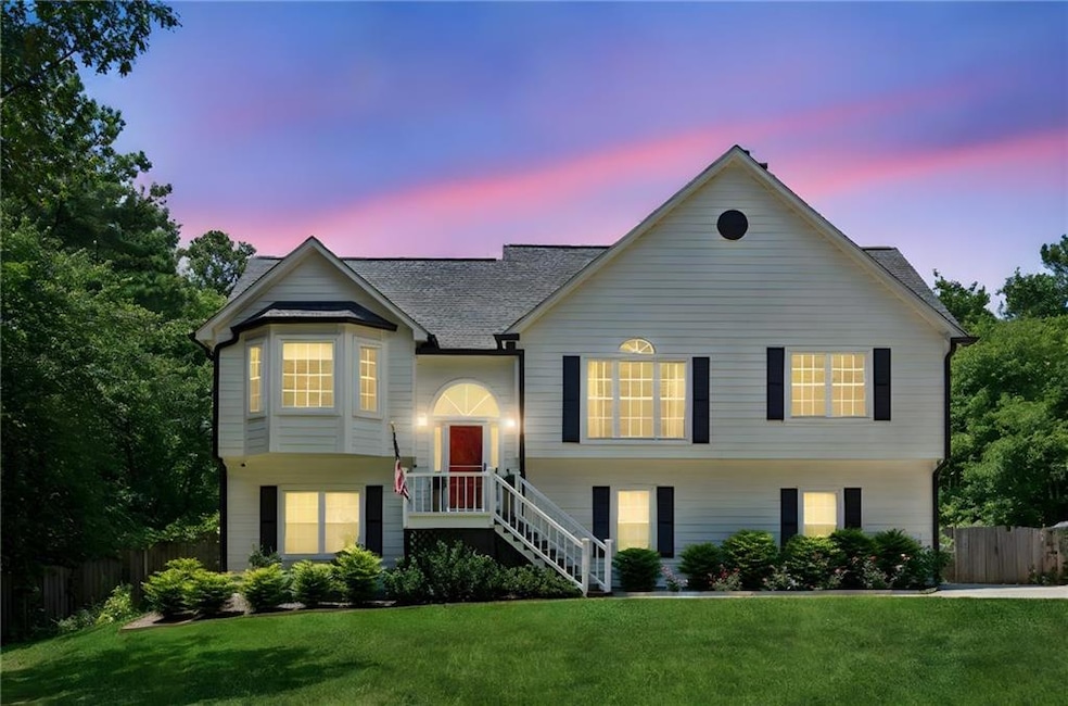 Raised ranch with a shingled roof