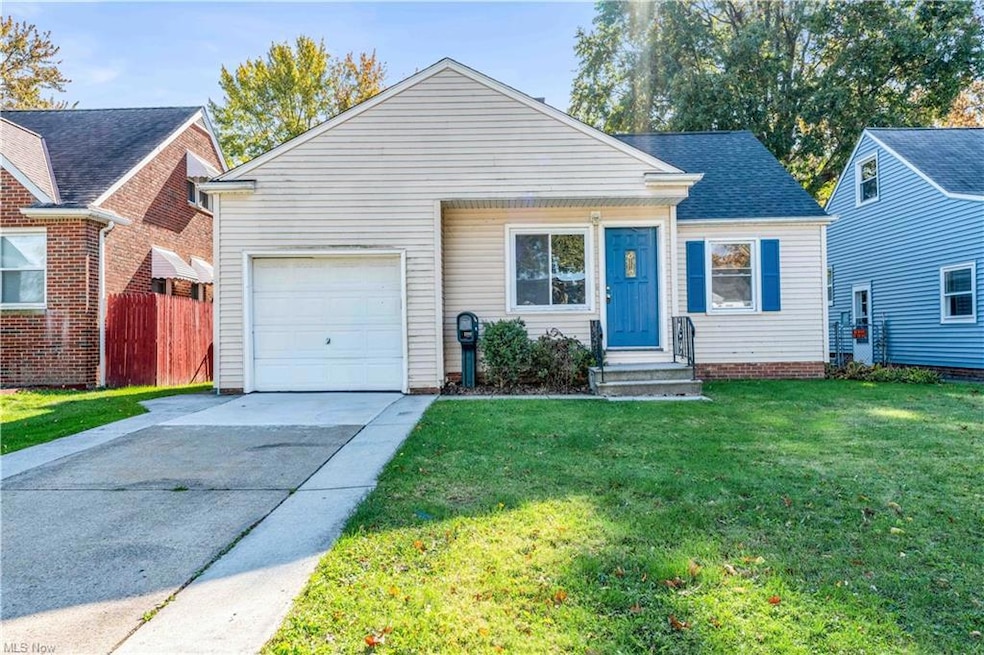 View of front of house featuring a front yard and a garage