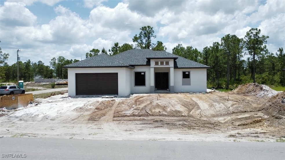 Prairie-style house featuring stucco siding, an at