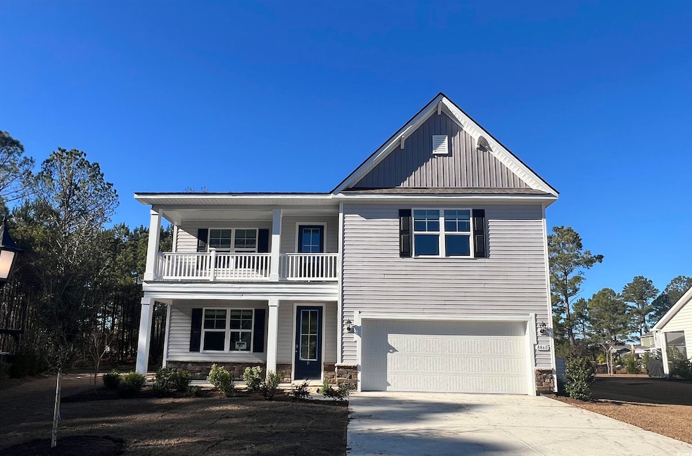 View of front of home with a balcony and a garage