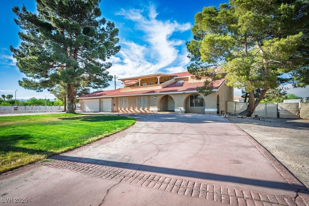 Mediterranean / spanish-style home featuring stucco siding, attached 3 car garage, a front lawn, half circle driveway, and a tiled roof