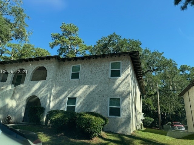 View of side of property with a yard