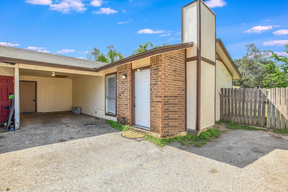 Entrance to property with brick siding, a chimney