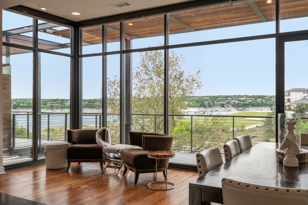Sunroom / solarium featuring a water view