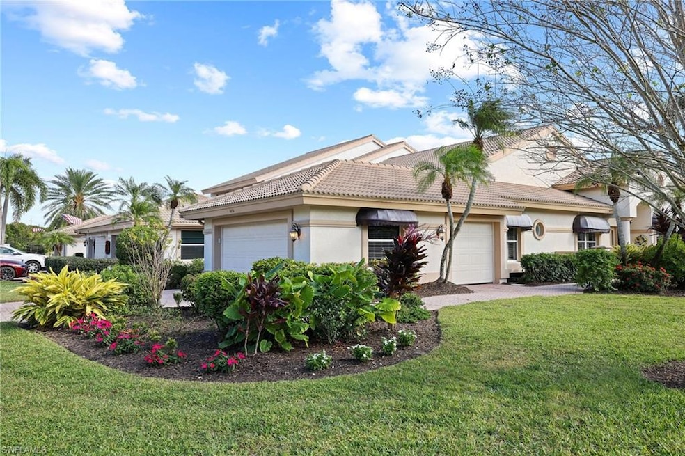 View of front of house with a garage and a front y