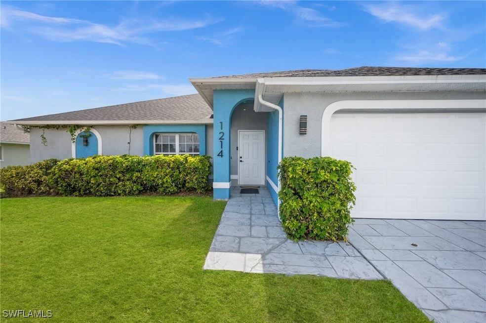Ranch-style home with a garage, stucco siding, a f