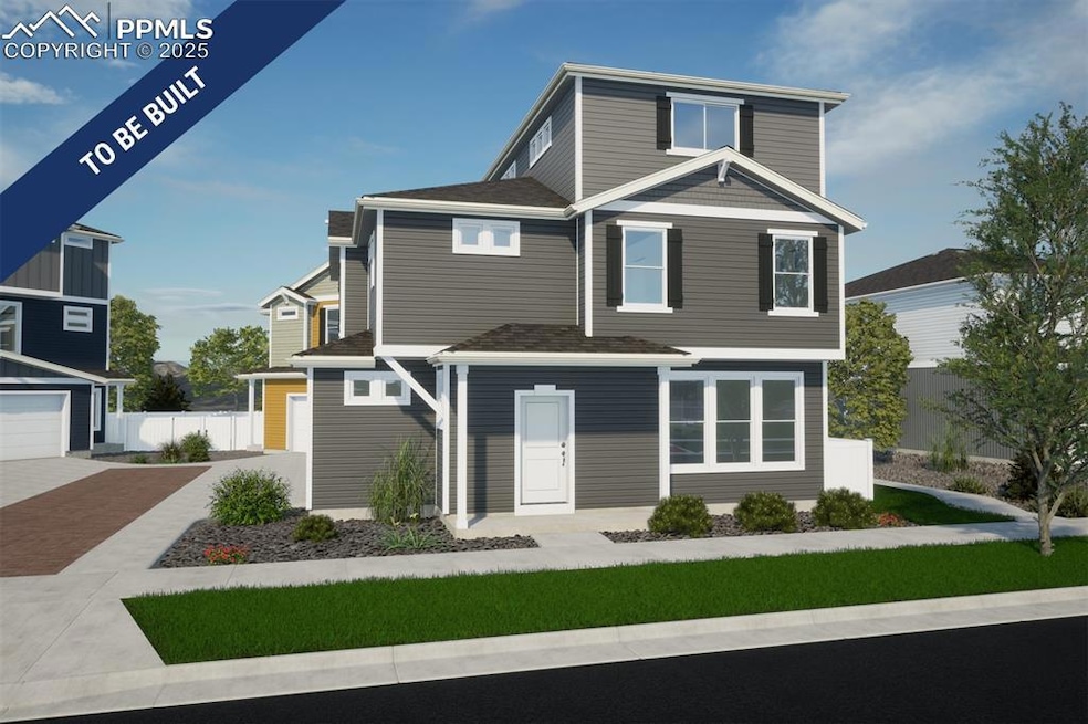 View of front of house with decorative driveway an
