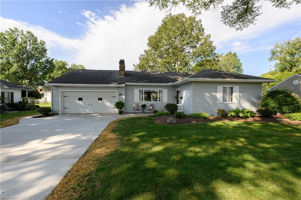 Ranch-style home with garage and a front yard