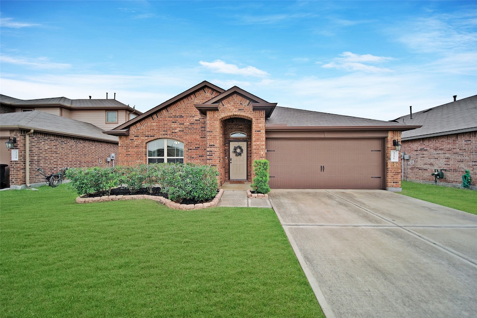 Welcome Home! Long drive way with lush landscaping.
