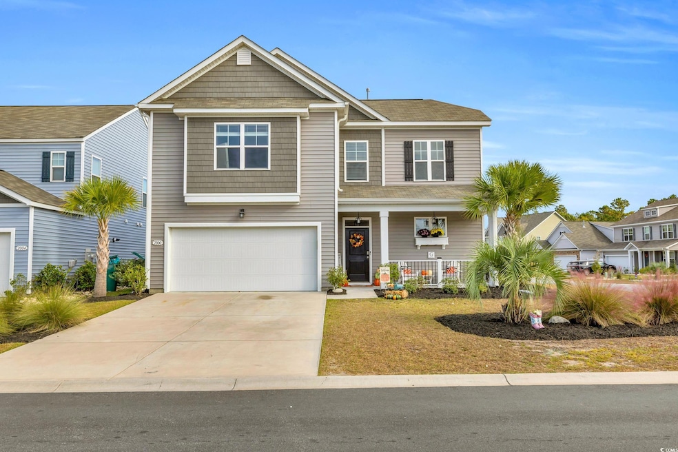 View of front of house with a garage and a porch