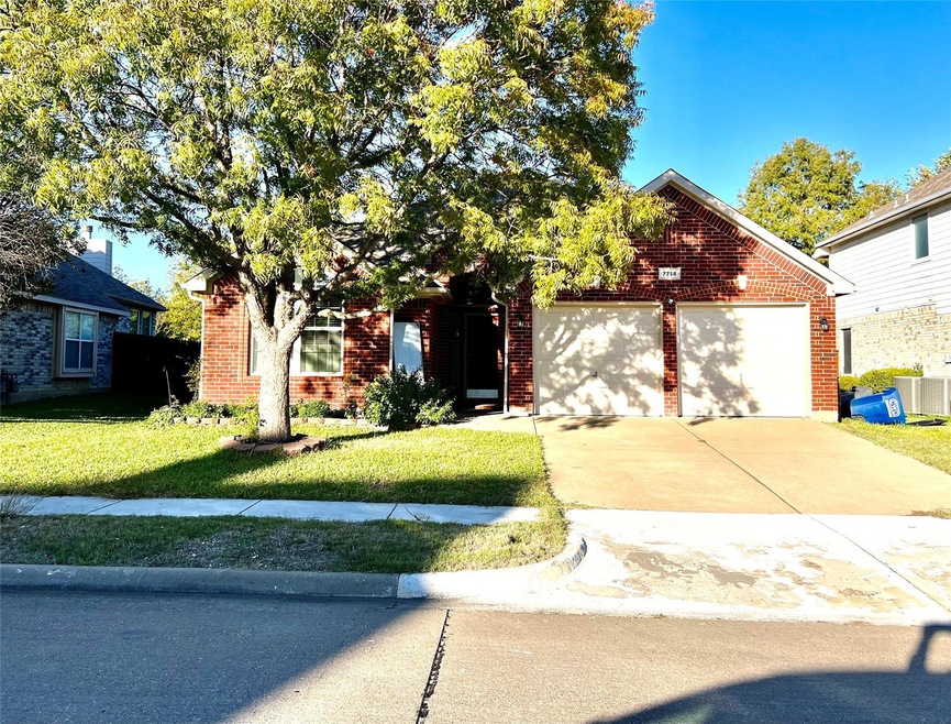 View of front of home featuring a garage and a front lawn
