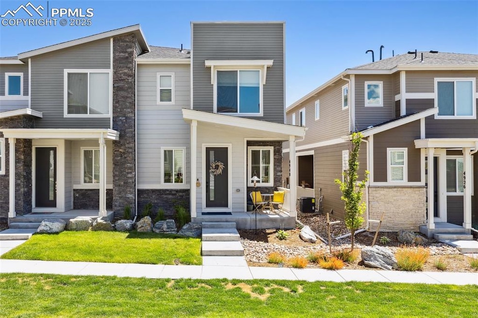 View of front of house featuring stone siding and a covered front porch