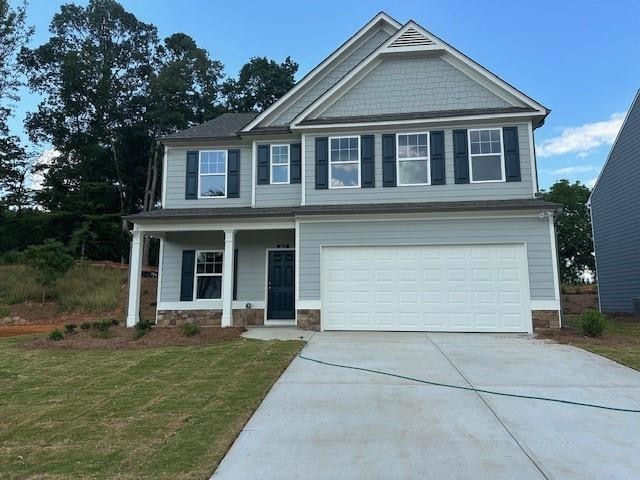 Craftsman inspired home with a garage and a front 