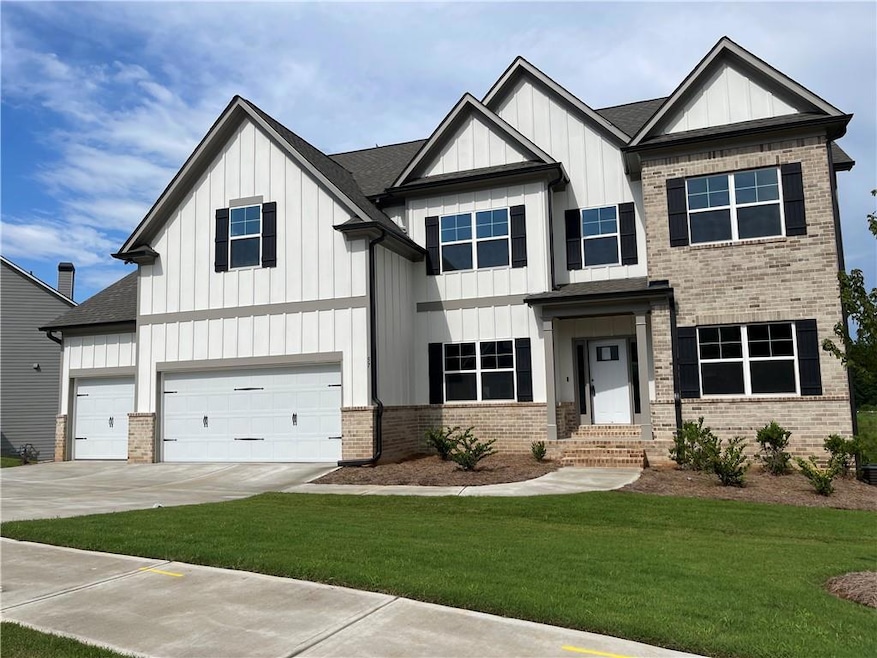 Craftsman-style home with a front yard and a garag