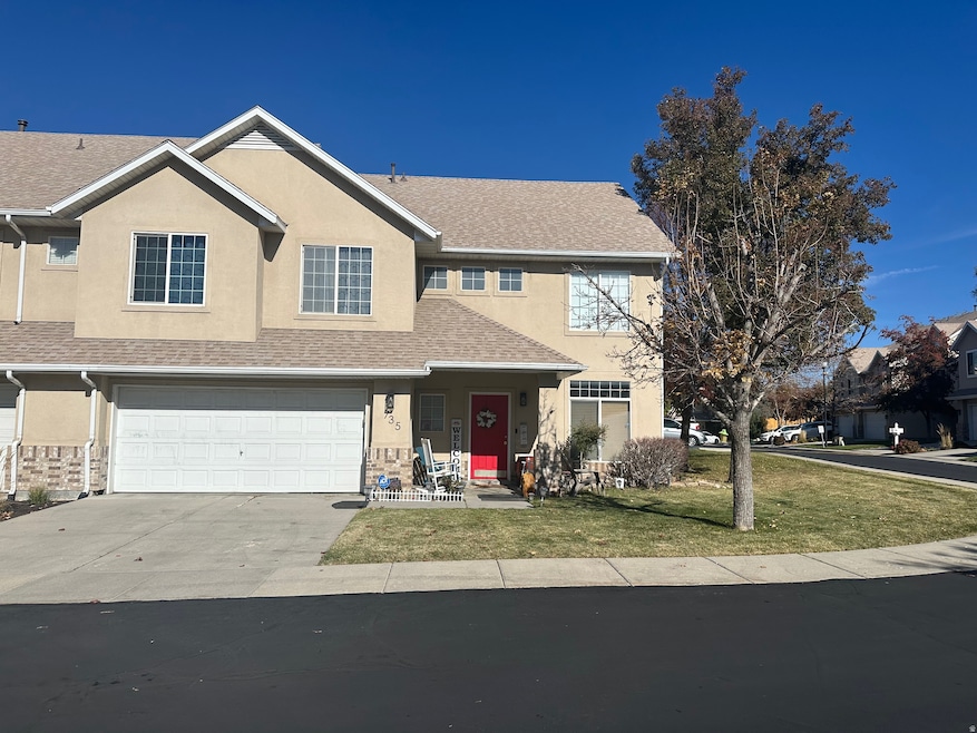 Traditional home with stucco siding, roof with shingles, concrete driveway, a porch, and an attached garage