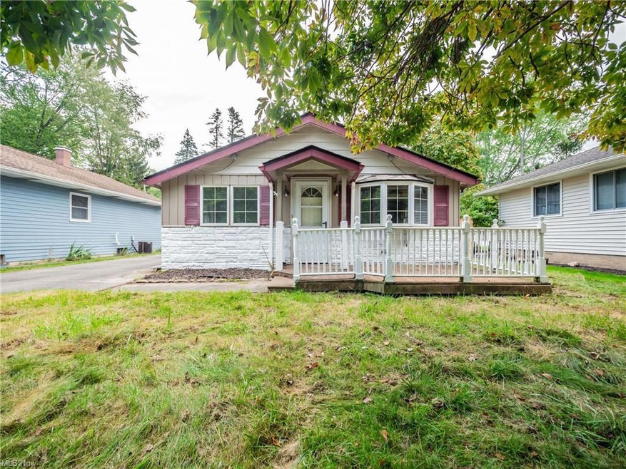 View of front of house with a front lawn and a dec