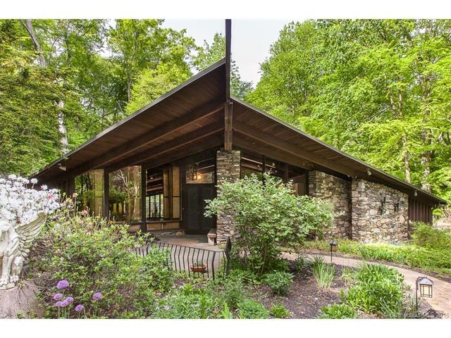 Front exterior...stone and glass architectural hom