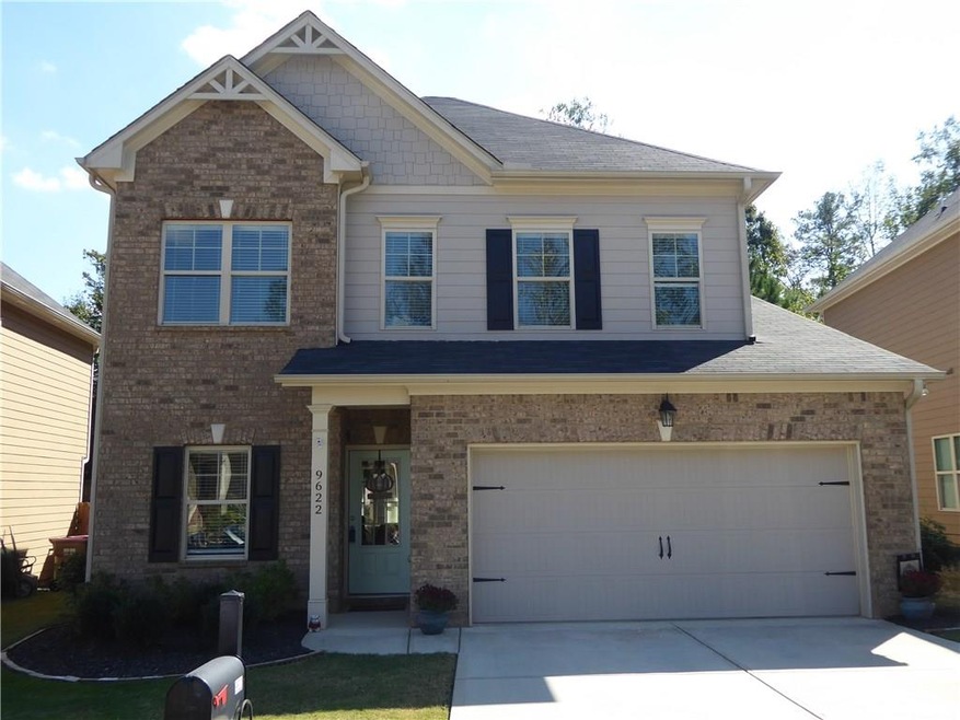 Front of home: covered entry with 2 car garage wit