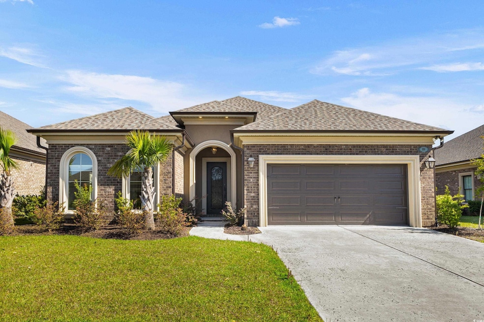 View of front of house with concrete driveway, roo