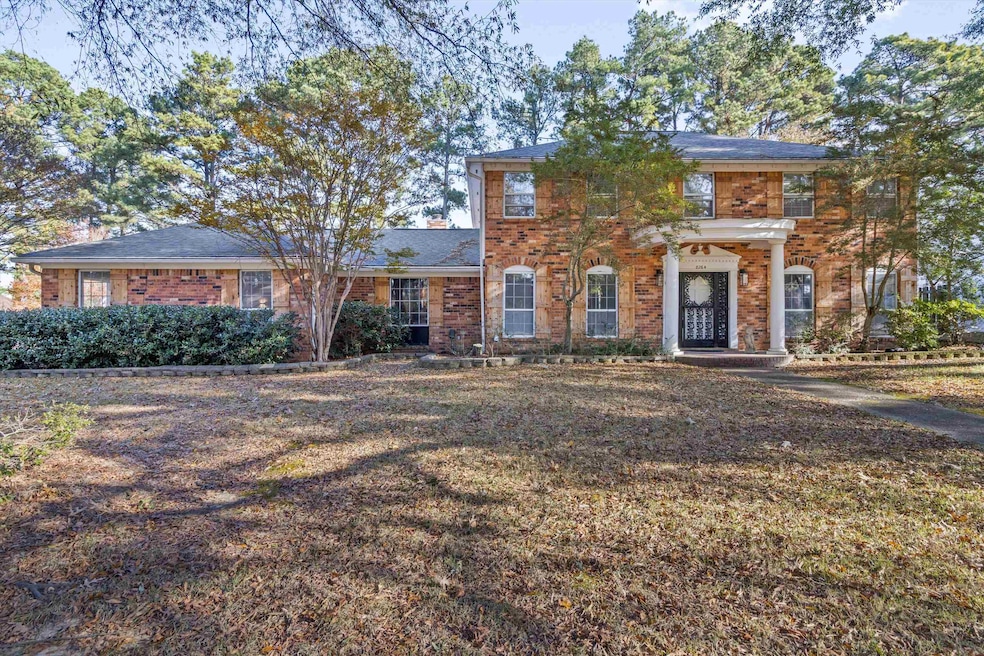 View of front of home featuring brick siding and a front lawn