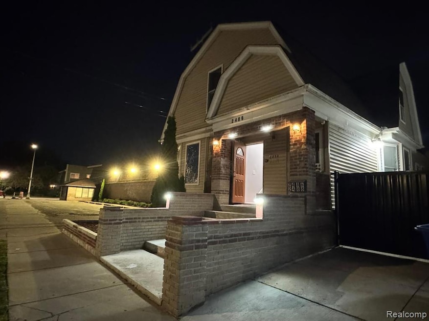 Exterior entry at night featuring a gambrel roof