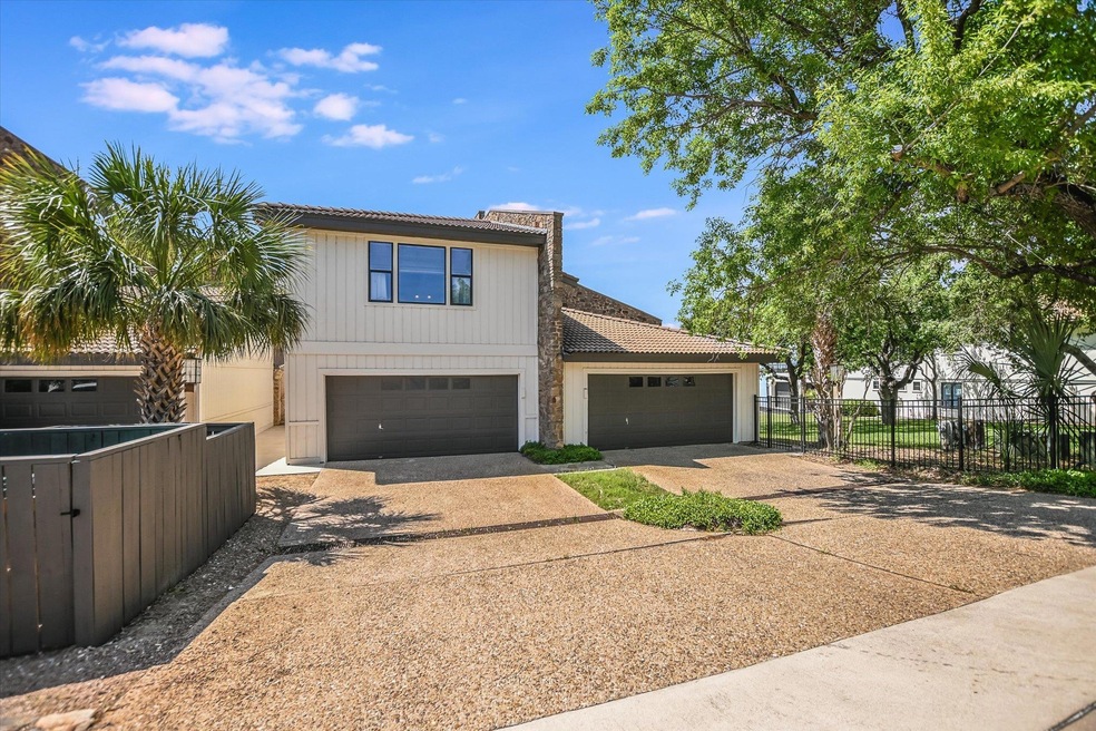View of front facade with concrete driveway, a ti
