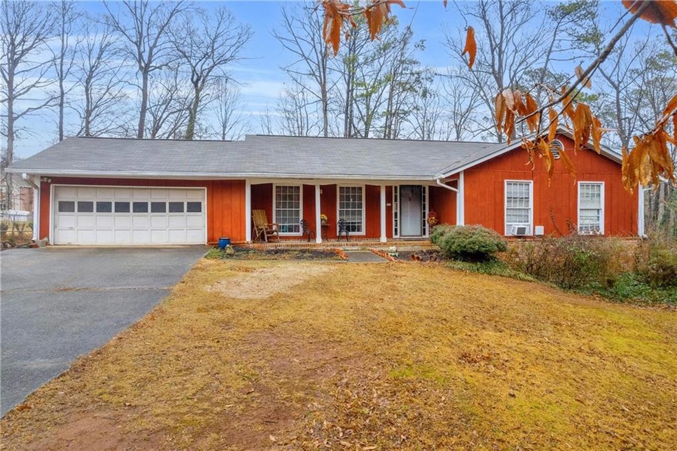 Ranch-style house with a garage, covered porch, an