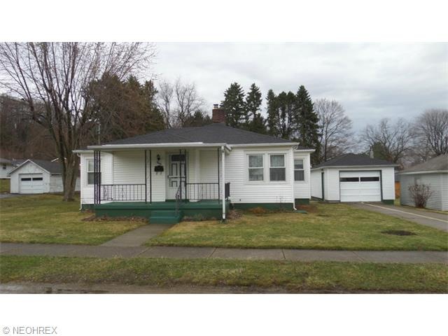 Front view of home with large side lot on left
