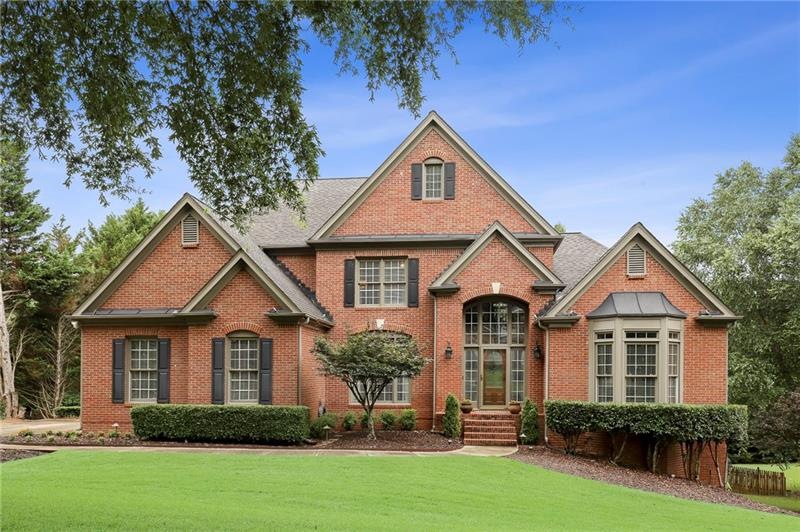 Stately 3 side brick beauty with outdoor landscape