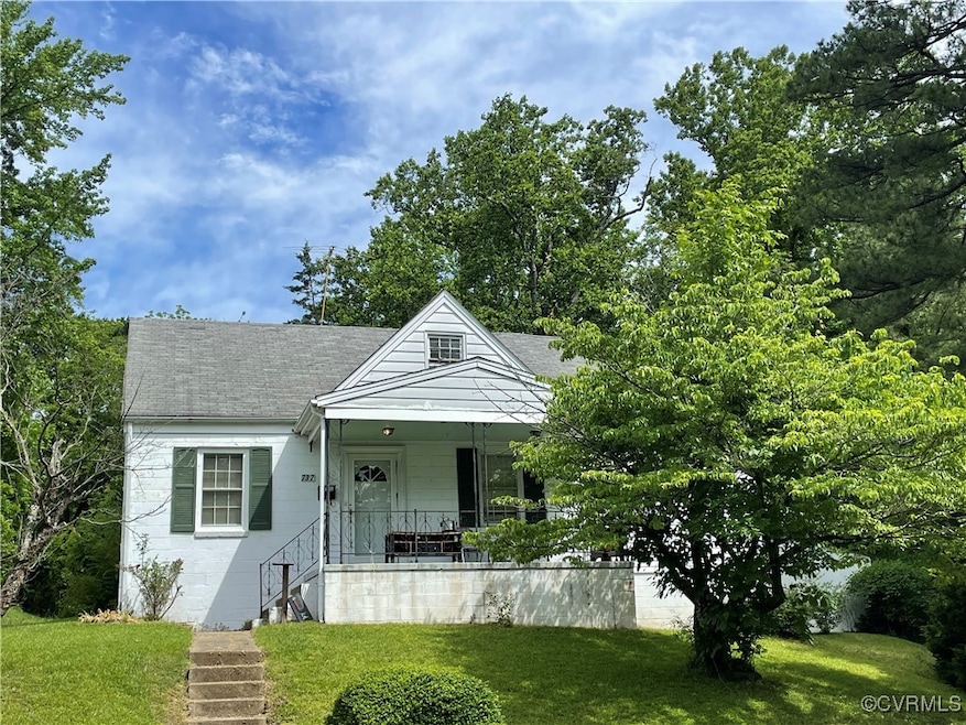 Bungalow with a porch, a front yard, stairs, and a