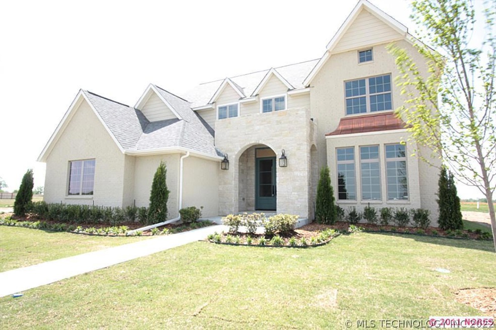 Stone and brick exterior with a THREE car side ent