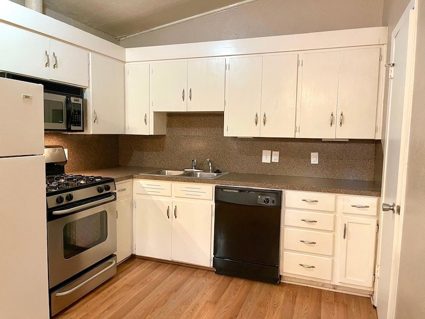 Kitchen with stainless steel range with gas cookt