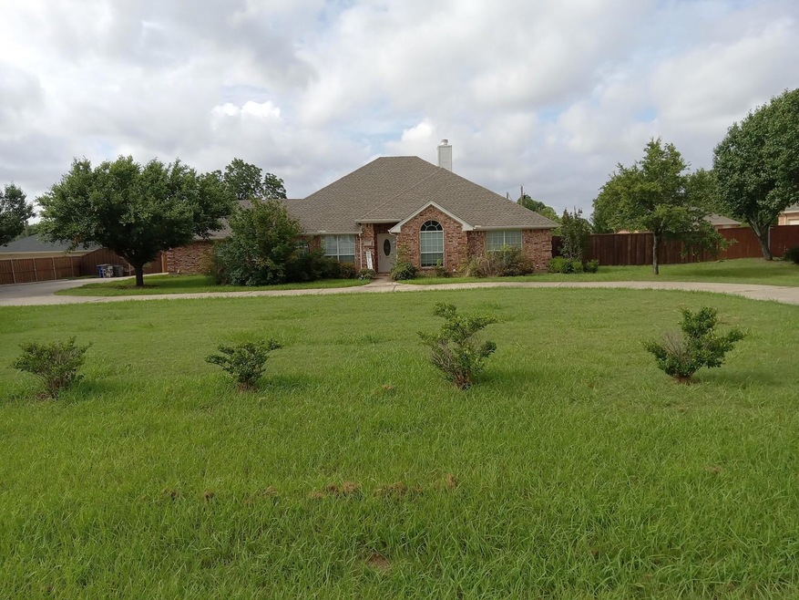 Front of home featuring large front yard and long drive up