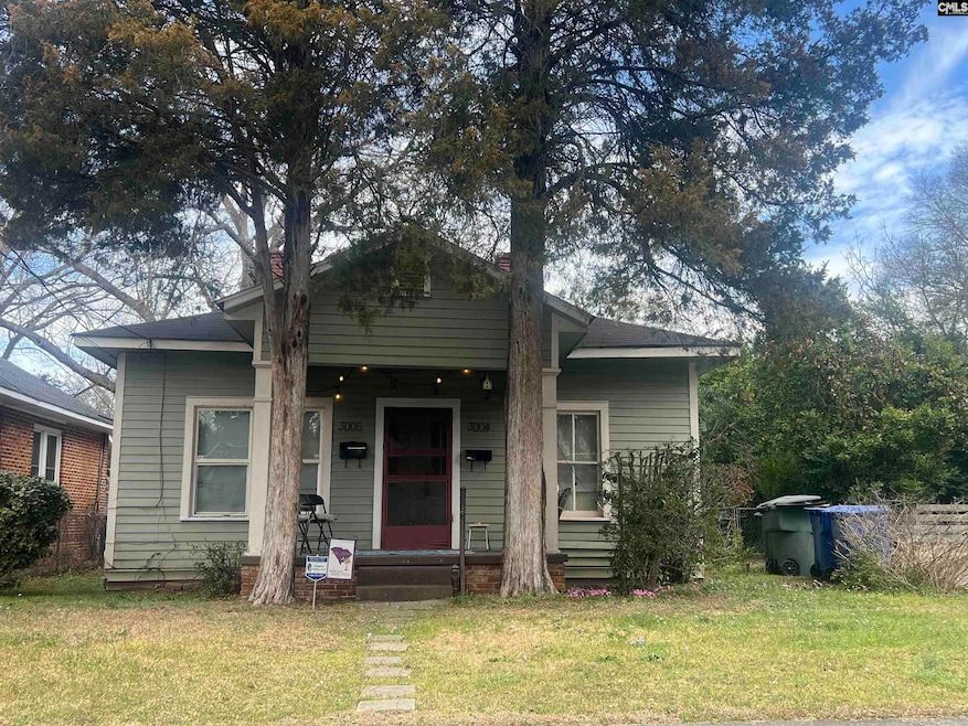 Porch, swing, and wonderful spring flowers grace this homey spot in the heart of Earlewood.