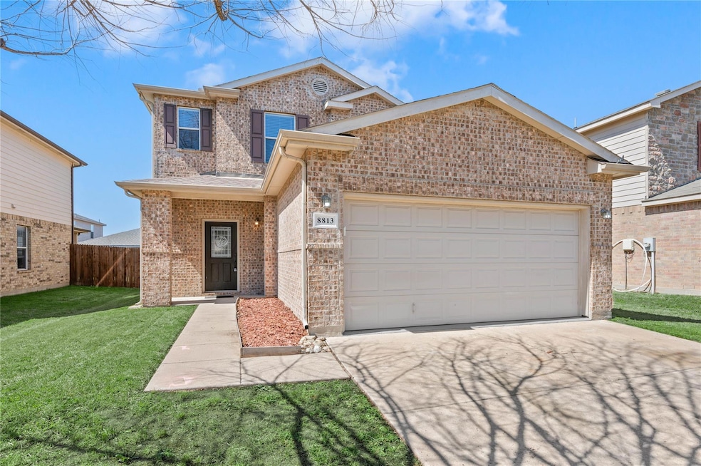 Traditional home with a front lawn, a garage, fenc