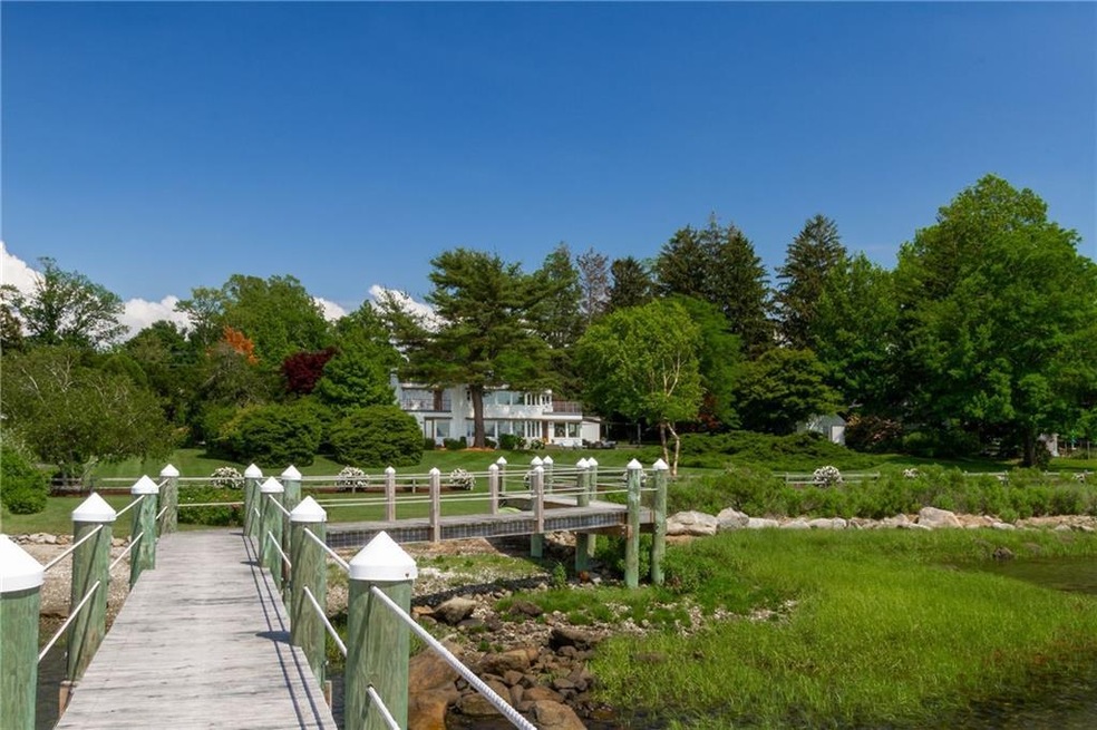 Sited on 1.8 lush acres, and 267 feet of private w