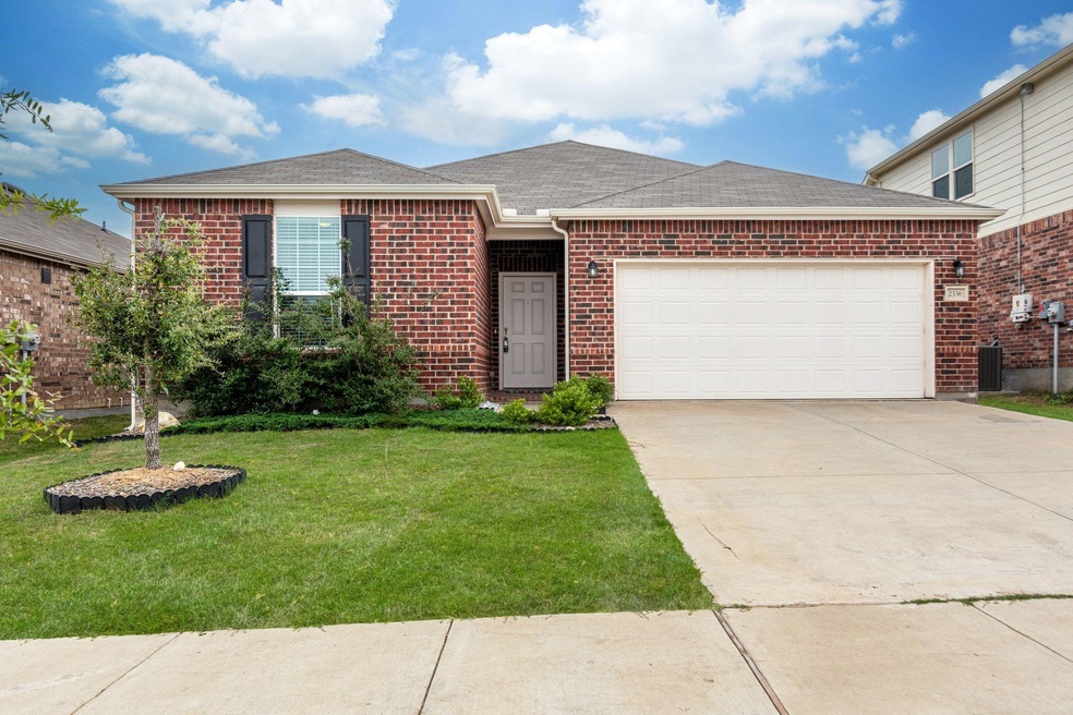 View of front facade with a garage and a front yar