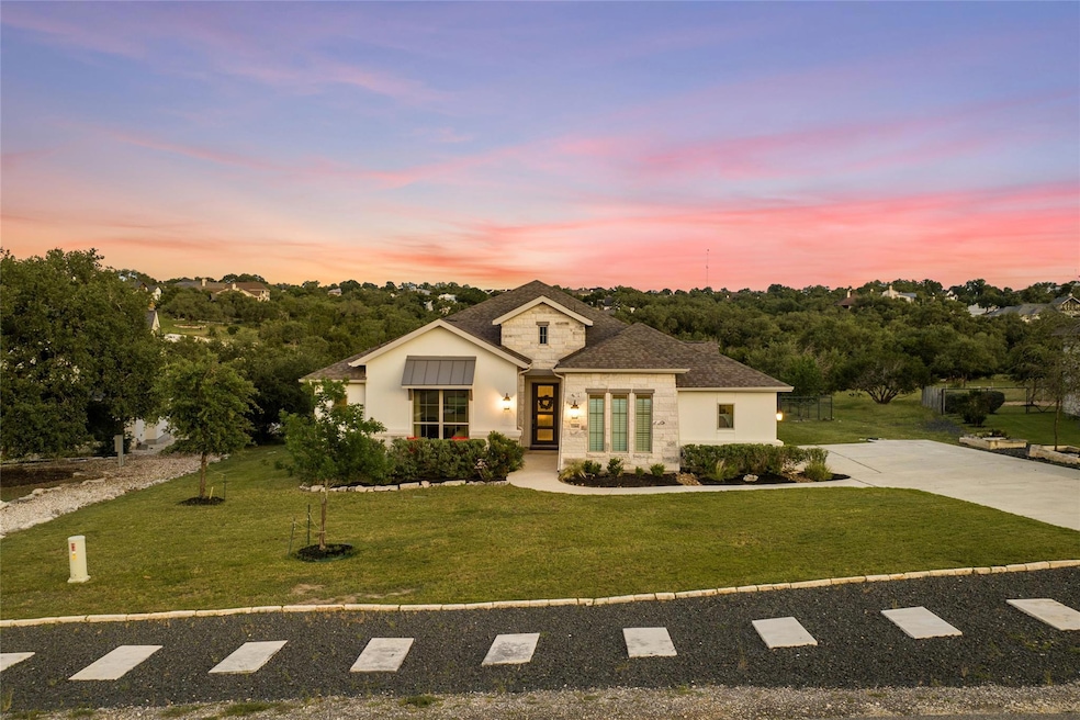 View of front of property with a lawn, stucco sid