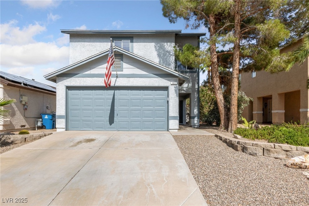View of front facade featuring driveway, stucco si