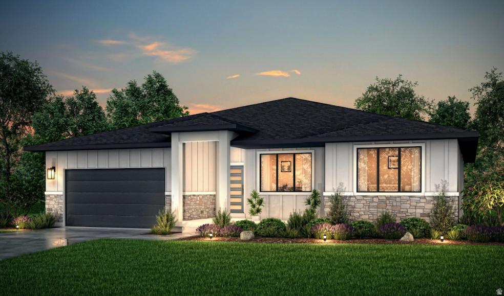 Prairie-style home featuring stone siding, board and batten siding, a yard, and a shingled roof