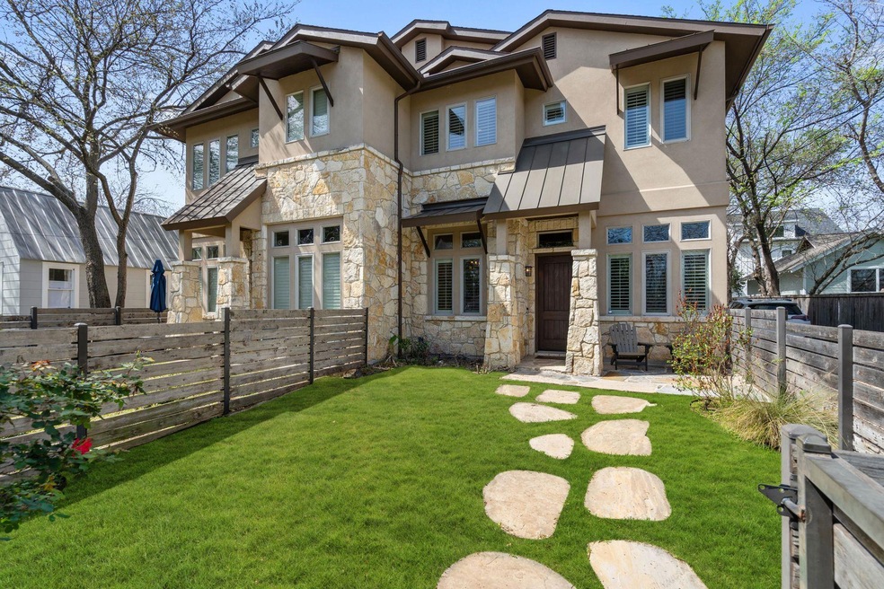 Back of property with stone siding, stucco siding