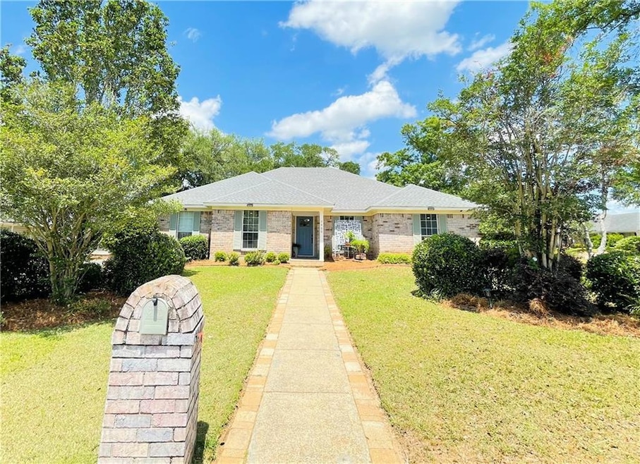 Ranch-style home with brick siding and a front law