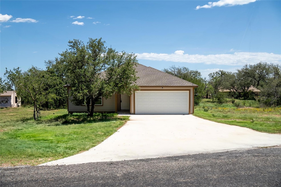 View of front of property with a garage, driveway